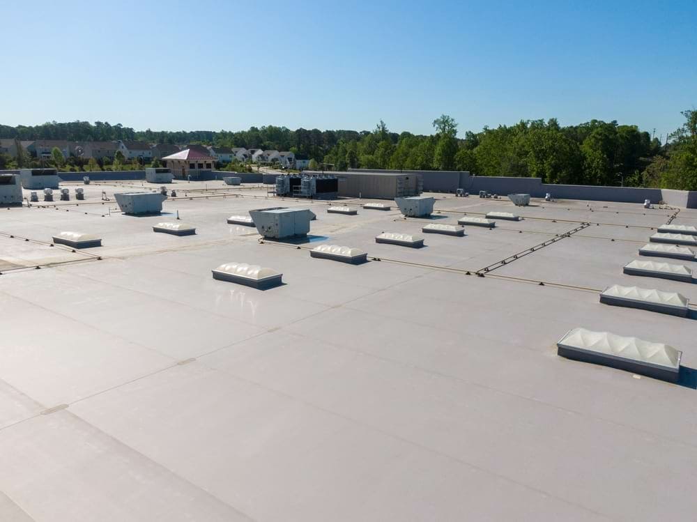 A commercial roofing system with skylights, HVAC equipment, and other components