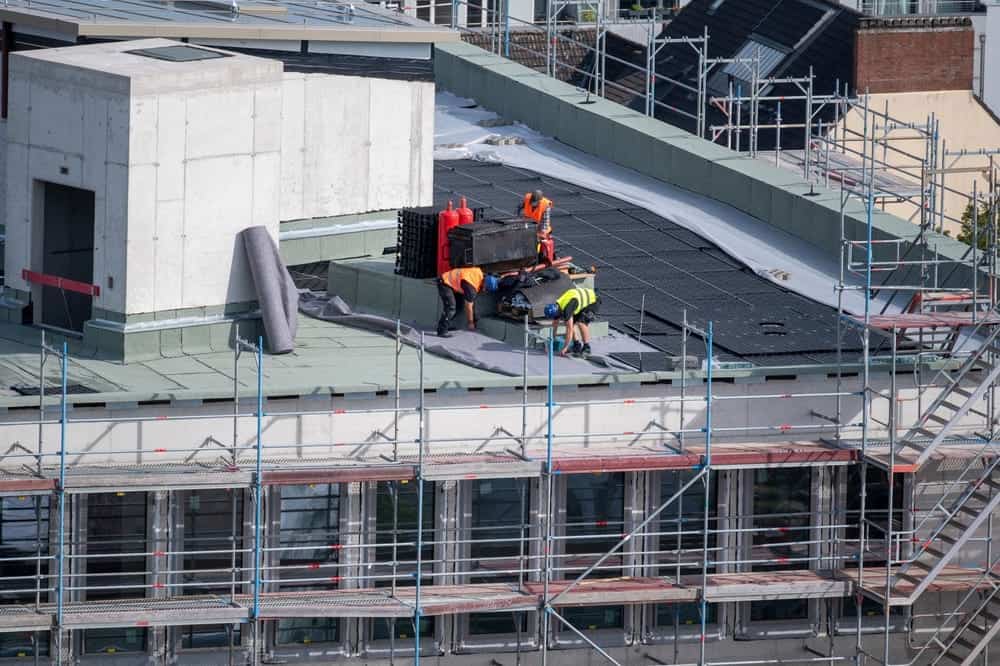 A crew of roofing professionals installing a commercial roofing system